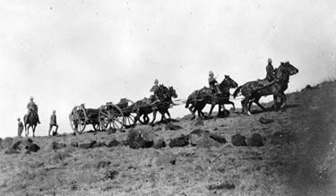 Mounted men with carriage crossing the Veldt