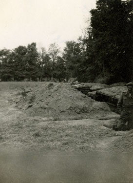 Battalion Headquarters dugout, Lieutenant Charles Harrington on the right.