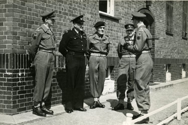 Captain R G Clutterbuck (with cane) talking to L to R - 2nd Lieut Bonner, a police inspector, CSM Hill (A Company), and Major Edwards (A Company).