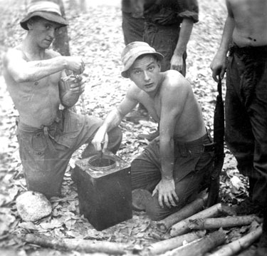 Unidentified soldiers cooking in a rubber plantation