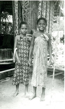 Two young Malayan girls in traditional dress.