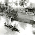 View: MR01521 A group of Malayan children sailing down the river in Kedah