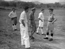 View: MR01720 Police Lieutenant, Major H T Roberts, District Officer John Day and Police Spt Sam Small standing on airstrip at Kroh