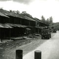 View: MR01762 Main street in Terap, showing patrol vehicles.