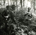 View: MR01795 Sergeant Roy Hughes on the left with the Civil Liaision Officer checking the identity card of a Tamil rubber tapper