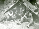 View: MR01811 Three unknown men camping under a jungle bivouac