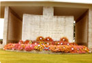 View: MR02314 Kranji Military Cemetery showing the large memorial stone in the centre of the Memorial Walls decorated with poppy wreaths.