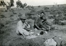 View: MR02421 Lieutenants J K Bleakley and J A C Taylor in reserve dugouts eating breakfast