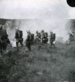 View: MR02539 Soldiers in gas masks rehearsing attack
