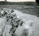 View: MR02546 Men in trench wearing gas masks and carrying rifles