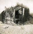 View: MR02569 Soldier outside rough hut in desert