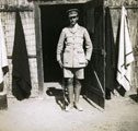 View: MR02579 Officer outside native hut