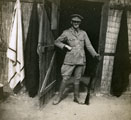 View: MR02580 Officer outside native hut