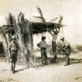 View: MR02628 Building brushwood shelter in desert