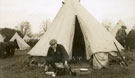 View: MR02838 New recruit in civilian dress checking his kit in front of tent