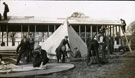 View: MR02924 Group of men from the Pals Battalions in the process of erecting tents at Heaton Park