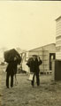 View: MR02936 Two men carrying supplies outside hutments in Heaton Park